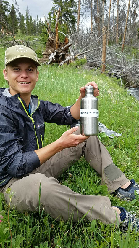 Ricky Jones poses with one of the water bottles used for collecting samples. Image: Ricky Jones